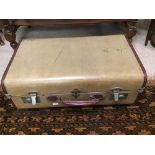 A VINTAGE LEATHER HANDLE OVERPOND SUITCASE