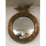 A VINTAGE CONVEX MIRROR WITH A GOLDEN EAGLE TO THE TOP A/F 40CMS DIAMETER