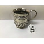 A LATE VICTORIAN SILVER CHRISTENING MUG, DECORATED THROUGHOUT WITH HIGHLY EMBOSSED DETAILING,