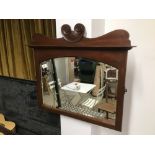 A MAHOGANY BEVELLED MIRROR