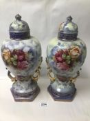A PAIR OF VICTORIAN LIDDED VASES DECORATED WITH FOLIAGE AND ROSES 44CMS
