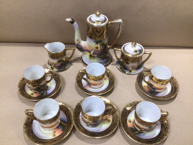 A JAPANESE NORITAKE SIX PIECE COFFEE SET DECORATED WITH A DESSERT SCENE