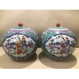 A PAIR OF CHINESE LIDDED JARS FAMILLE ROSE 21CM