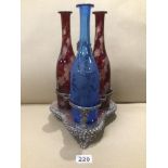 A SILVER PLATED DECANTER SET WITH ETCHED BLUE AND RUBY RED BOTTLES R20
