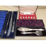 A PAIR OF PLATED AND ENGRAVED FISH SERVERS, THREE PIECE BONE HANDLED CARVING SET AND SIX SILVER
