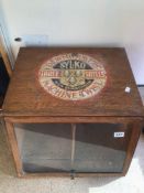 A VINTAGE TABLETOP ADVERTISING SEWING CABINET ON SWIVEL BASE (DEWHURSTS)