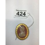 A CARVED OVAL CAMEO CARNELIAN IN A TEST 14CT OR HIGHER GOLD OVAL MOUNT WITH APPLIED BEAD AND ROPE