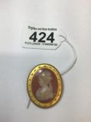 A CARVED OVAL CAMEO CARNELIAN IN A TEST 14CT OR HIGHER GOLD OVAL MOUNT WITH APPLIED BEAD AND ROPE