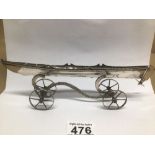 AN UNMARKED SILVER LONGBOAT/CANOE ON STAND 161 GRAMS