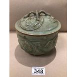 A CHINESE CELADON LIDDED POT WITH EMBOSSED DECORATION