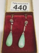 A PAIR OF JADE DROP EARRINGS WITH DIAMOND SET BARS AND CLUSTER TOPS ON SCREWS (1 DIAMOND MISSING)