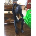 AN EBONISED WOODEN FIGURE 33CM