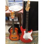 TWO GUITARS A RED ASHTON ELECTRIC GUITAR WITH A CHILDS ACOUSTIC GUITAR
