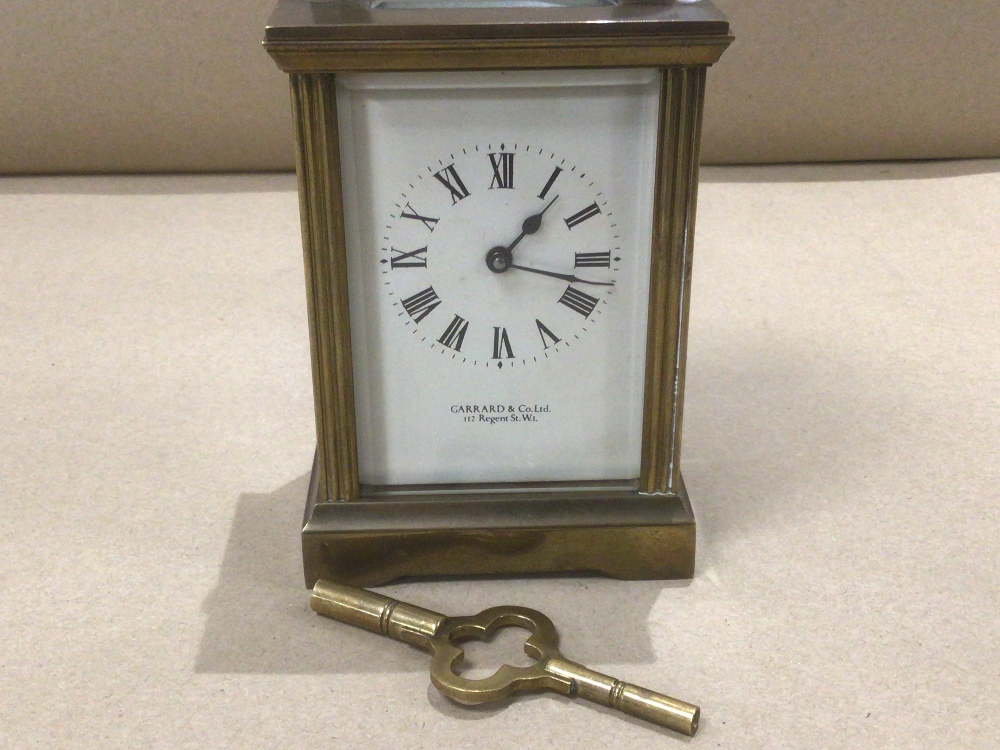 AN ENGLISH GARRARD AND CO LONDON BRASS CARRIAGE CLOCK WITH KEY