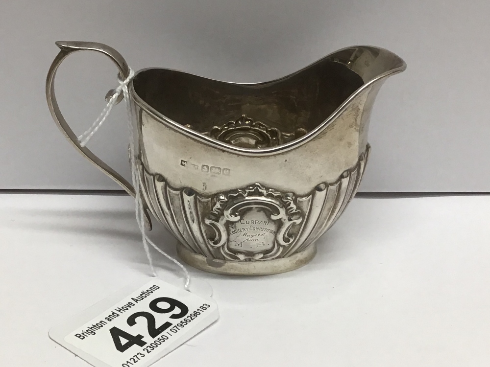 AN OVAL HALLMARKED SILVER HALF FLUTED CREAM JUG, 78 GRAMS