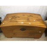 A DOME TOP CAMPHOR WOODEN CHEST WITH TRAY INSERT AND ORIENTAL CARVED SCENES