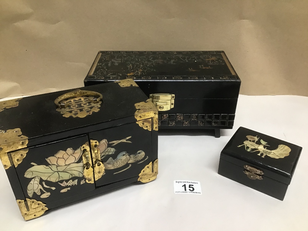 THREE BLACK LACQUERED JEWELLERY BOXES WITH MOTHER IN PEARL AND DECORATED WITH ANIMALS AND RIVER