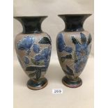 A PAIR OF DOULTON AND SLATERS GLAZED STONEWARE VASES WITH TUBE LINED FLORAL DECORATION 28CM (1 RIM