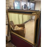 A LARGE GILDED BEVELLED EDGED MIRROR WITH A WOODEN GILDED AND EBONISED FRAME 119 X 93CM