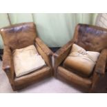 A PAIR OF 1920'S BROWN LEATHER ARMCHAIRS