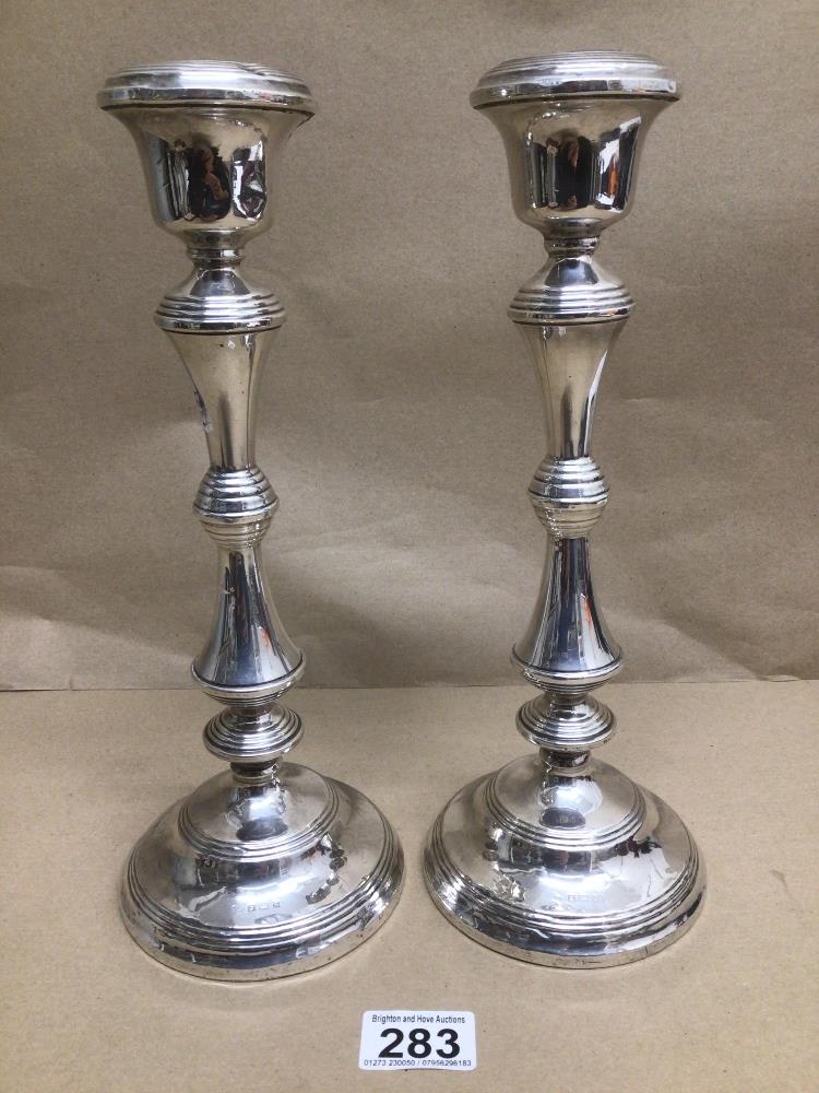 A PAIR OF WEIGHTED HALLMARKED SILVER CANDLESTICKS BY W.I BROADWAY AND CO 1958 31CMS TOTAL WEIGHT