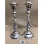 A PAIR OF WEIGHTED HALLMARKED SILVER CANDLESTICKS BY W.I BROADWAY AND CO 1958 31CMS TOTAL WEIGHT