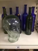 A QUANTITY OF GLASS BOTTLES WITH A GLASS HEAD