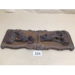 A BLACK FOREST STYLE CARVED WOODEN BOOK/SLIDE STAND WITH CARVED DOGS