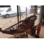 A LARGE IMPRESSIVE WOODEN DHOW/ BOAT ON STAND MADE IN OMAN 2001 168 X 192 CM