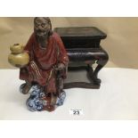 A TERRACOTTA CHINESE FIGURE ON A CHINESE LACQUERED STAND FIGURE 25CM