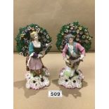 A PAIR OF 19TH CENTURY SAMPSON PORCELAIN DERBY STYLE FIGURES WITH BOCAGE BACKGROUNDS- GOLD ANCHOR