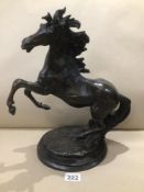 AN UNMARKED BRONZE OF A SCULPTURED REARING HORSE 40CM HIGH