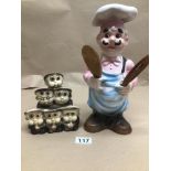 A CHINA POTTERY KITCHEN CHEF 30CMS WITH A SET OF MONKS FOR HOLDING EGGS