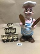 A CHINA POTTERY KITCHEN CHEF 30CMS WITH A SET OF MONKS FOR HOLDING EGGS