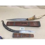 TWO EASTERN DAGGERS WITH SHEATHS ONE WITH A HORN CARVED HANDLE WITH MOTHER OF PEARL INLAY AND ONE