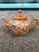 A SMALL CHINESE ORANGE TEAPOT WITH CHASING DRAGONS MARKS TO BASE