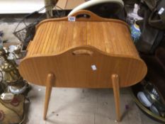 A VINTAGE 1960'S TEAK ROLL TOP SEWING BOX ON SPLAYED LEGS