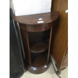 A ROSEWOOD CRESCENT SHAPE SMALL SHELF UNIT 69 X 38CM