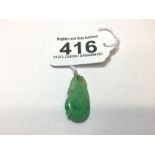 A CARVED GREEN JADE DROP ON A YELLOW METAL LOOP