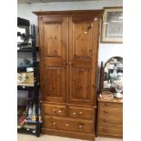 A LARGE DOUBLE VINTAGE PINE WARDROBE WITH THREE BOTTOM DRAWERS (COMES APART) 203 X 92 X 51CM