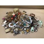 A LARGE BOX OF COSTUME JEWELLERY WITH A COMPACT