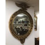 A LARGE GILDED CONVEX BEVELLED MIRROR WITH AN EAGLE TO TOP 132 X 92CCM
