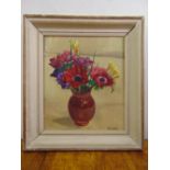 A framed oil on canvas still life of flowers, indistinctly signed bottom right, 40 x 34cm