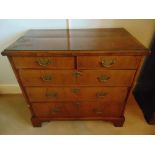 A rectangular mahogany chest of drawers with brass swing handles, on four bracket feet