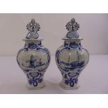 A pair of blue and white vases in the Dutch style decorated with flowers and leaves, the pull off