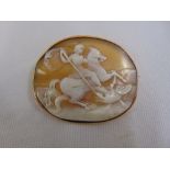 An Edwardian carved cameo brooch of St George and the Dragon set in a 9ct gold frame