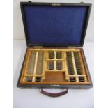 An early 20th century Opticians lens testing kit in fitted leather travel case