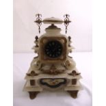 A marble mantle clock of stepped rectangular form the black enamel dial with gilded Roman