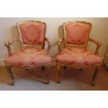 A pair of French style upholstered bedroom armchairs on cabriole legs