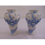 A pair of continental porcelain vases decorated with butterflies, swags and applied flowers, marks